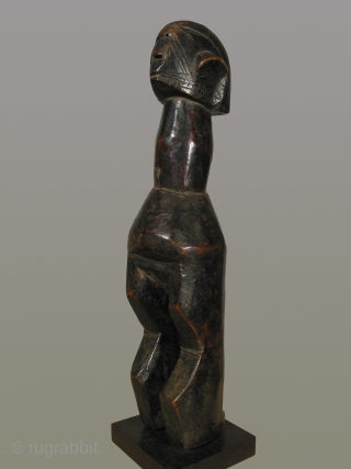 Africa, Mumuye wood figure, Nigeria, Benue River Valler Region, height 18 inches, circa 1900-1950, fine dark patina. Provenance:Gallery Argile, Paris
Facial features of eyes, nose, and mouth are flattened onto the form of  ...