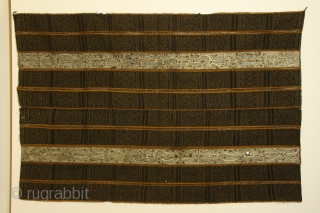 Woman's ceremonial wrapper ( tapis), Lampung region, S. Sumatra, Indonesia, cotton with resist dyed patterning ( ikat) and silk embroidery, 19th century or earlier; the center horizontal line, where the two halves  ...