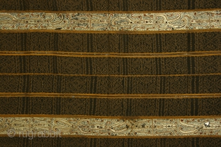 Woman's ceremonial wrapper ( tapis), Lampung region, S. Sumatra, Indonesia, cotton with resist dyed patterning ( ikat) and silk embroidery, 19th century or earlier; the center horizontal line, where the two halves  ...