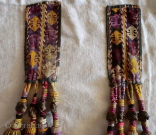 Pair of Uzbek Lakai Tassels. 
Very nice pair of Lakai tassels on cross stitched panels. The tassel knots are bound in metal thread.

They each measure 2-1/2" by 23"     