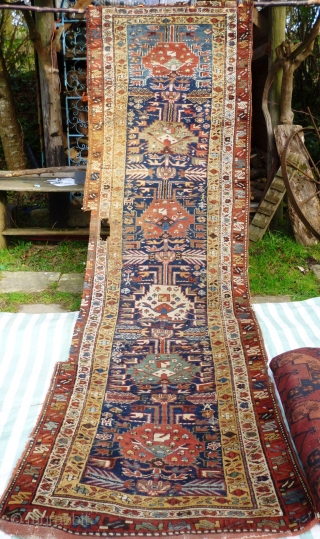 North West Persian Runner. Fragmented: missing outer border section, heat related damage in same area. Otherwise full pile with minimal damage. Good colours and interesting anthropomorphic motifs - see photos. Needs a  ...