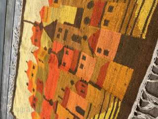 Polish artist rug from the 1970s. Wool on This vintage Polish folklore kilim wall hanging beautifully captures a traditional village scene with bold color blocks and stylized forms. In warm tones of  ...
