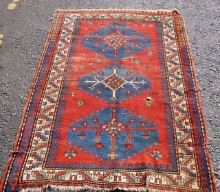 Antique Kazak rug. Circa 1900.175cm x 114cm.All good dyes.Small hole to fiels and some wear.                  