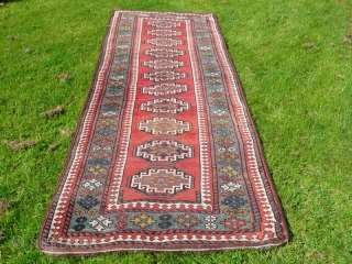 Attractive Moghan long rug, with lovely green border, size 10' x 3'.10".  Good overall condition, has been cleaned and fringes replaced.           