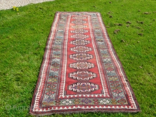 Attractive Moghan long rug, with lovely green border, size 10' x 3'.10".  Good overall condition, has been cleaned and fringes replaced.           