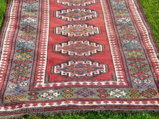 Attractive Moghan long rug, with lovely green border, size 10' x 3'.10".  Good overall condition, has been cleaned and fringes replaced.           