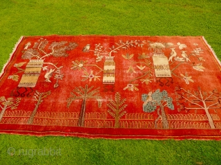 Charming 1930's Khotan 'landscape' rug decorated with trees, vases and birds - convincing enough to make a cat curious (see image 5). Condition, some areas of wear and old moth damage but  ...