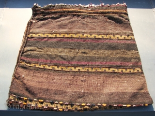 Bruised Beluch/Baluch half khorjin, field filled with s-shaped tiles. First Q. 20th.C. Washed and cleaned, some antique moth bites. Ca. 66 x 68 cm. Condition ; bruised . Oxidation in blacks and  ...