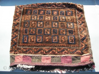 Bruised Beluch/Baluch half khorjin, field filled with s-shaped tiles. First Q. 20th.C. Washed and cleaned, some antique moth bites. Ca. 66 x 68 cm. Condition ; bruised . Oxidation in blacks and  ...