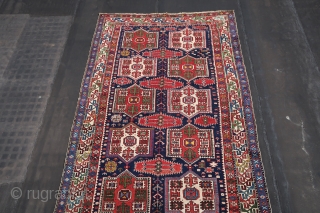  Shirwan / Shirvan .( Kuba Shahnazarli Rug ) In the dark blue field ,surrounded by the main eagle beaked borders , twelve cartouche medallions have been aligned vertically in two rows  ...