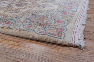 Kerman Runner

3.0 by 14.3
0.91 x 4.35

The old ivory field of this high pile SE Persian Kerman has a Westernizing floral bouquet and acanthus design within open millefleurs and tendril borders in the  ...