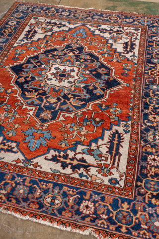 Antique Persian Serapi Rug, circa 1900. Featuring a bold geometric medallion on an ivory field with rich red and deep indigo accents, framed by a classic Heriz-style border. Strong Northwest Persian village  ...