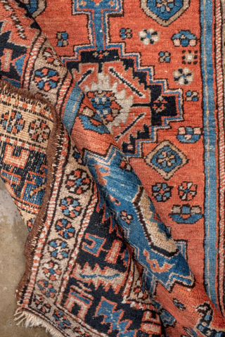 Antique Persian Heriz Rug, circa 1910. Featuring geometric medallions on a warm coral field with soft blue and ivory accents, framed by a bold tribal border. Classic Northwest Persian village design with  ...