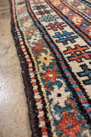 Antique Persian Kurdish Rug, circa 1920. Featuring an allover geometric medallion pattern on a deep indigo field with soft coral and ivory accents, framed by multiple tribal borders. Bold village weaving with ...