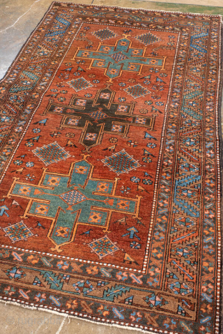 Antique Persian Heriz Rug, circa 1910. Featuring bold geometric medallions on a warm rust field with turquoise and ivory accents, framed by a classic angular Heriz border. Strong village weaving with lively  ...