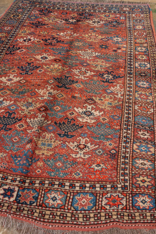 Antique Kurdish Rug, circa 1900. Featuring an allover tribal pattern on a warm rust field with soft blue and ivory accents, framed by a geometric star border. Lively village weaving with bold  ...