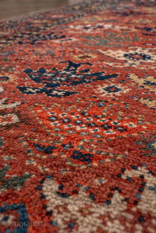 Antique Kurdish Rug, circa 1900. Featuring an allover tribal pattern on a warm rust field with soft blue and ivory accents, framed by a geometric star border. Lively village weaving with bold  ...