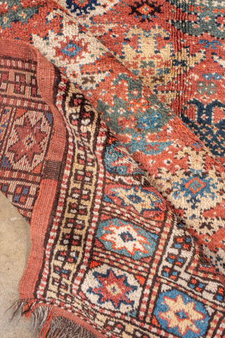 Antique Kurdish Rug, circa 1900. Featuring an allover tribal pattern on a warm rust field with soft blue and ivory accents, framed by a geometric star border. Lively village weaving with bold  ...