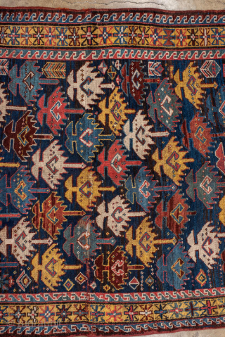 Antique Persian Kurdish Runner, circa 1910. Featuring an allover stylized boteh motif on a dark field with vibrant red, blue, and ivory accents, framed by simple geometric borders. Bold tribal design with  ...