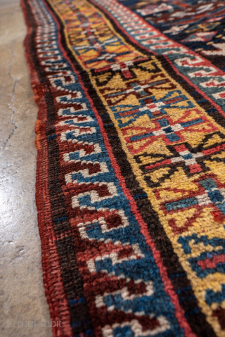 Antique Persian Kurdish Runner, circa 1910. Featuring an allover stylized boteh motif on a dark field with vibrant red, blue, and ivory accents, framed by simple geometric borders. Bold tribal design with  ...