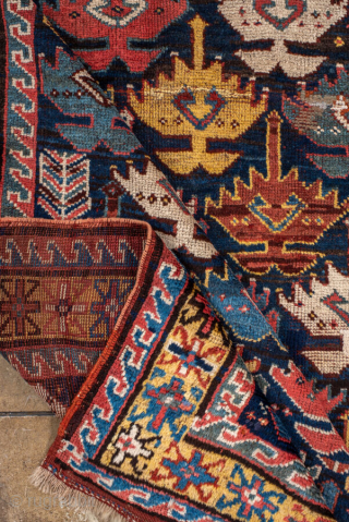 Antique Persian Kurdish Runner, circa 1910. Featuring an allover stylized boteh motif on a dark field with vibrant red, blue, and ivory accents, framed by simple geometric borders. Bold tribal design with  ...