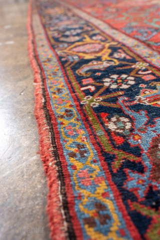 Antique Persian Bidjar Runner, circa 1900. Featuring an elegant repeating medallion design on a rich red field with deep indigo and ivory accents, framed by a classic floral border. Dense, durable weave  ...