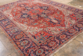 Antique Persian Heriz Carpet, circa 1900. Featuring a dramatic geometric medallion on a rich red field with deep indigo and ivory accents, framed by a classic Heriz border. Bold Northwest Persian design  ...