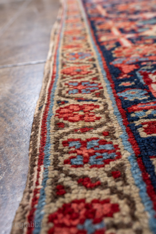 Antique Persian Heriz Carpet, circa 1900. Featuring a dramatic geometric medallion on a rich red field with deep indigo and ivory accents, framed by a classic Heriz border. Bold Northwest Persian design  ...
