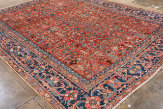 Antique Persian Heriz Carpet, circa 1900. Featuring an intricate allover floral design on a rich red field with deep indigo and ivory accents, framed by a bold Heriz border. Classic Northwest Persian  ...