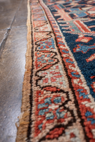 Antique Persian Heriz Carpet, circa 1900. Featuring an intricate allover floral design on a rich red field with deep indigo and ivory accents, framed by a bold Heriz border. Classic Northwest Persian  ...