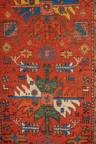Antique Persian Heriz Runner, circa 1910. Featuring bold geometric medallions on a vibrant red field with blue and ivory accents, framed by a classic Heriz border. Strong Northwest Persian village design with  ...