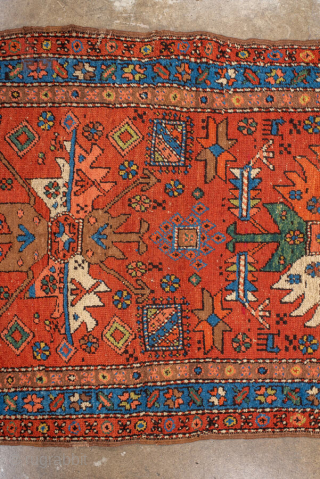 Antique Persian Heriz Runner, circa 1910. Featuring bold geometric medallions on a vibrant red field with blue and ivory accents, framed by a classic Heriz border. Strong Northwest Persian village design with  ...