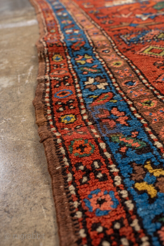 Antique Persian Heriz Runner, circa 1910. Featuring bold geometric medallions on a vibrant red field with blue and ivory accents, framed by a classic Heriz border. Strong Northwest Persian village design with  ...