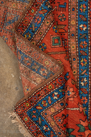 Antique Persian Heriz Runner, circa 1910. Featuring bold geometric medallions on a vibrant red field with blue and ivory accents, framed by a classic Heriz border. Strong Northwest Persian village design with  ...