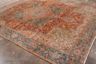 Antique Persian Heriz Carpet, circa 1900. Featuring a bold geometric medallion on a softly faded rust field with pale blue and ivory accents, framed by a classic Heriz border. Northwest Persian design  ...