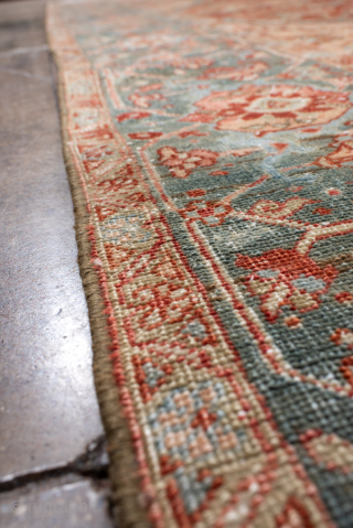 Antique Persian Heriz Carpet, circa 1900. Featuring a bold geometric medallion on a softly faded rust field with pale blue and ivory accents, framed by a classic Heriz border. Northwest Persian design  ...