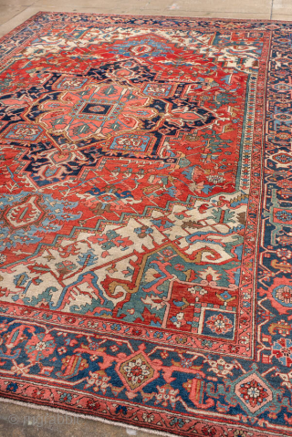 Antique Persian Heriz Carpet, circa 1900. Featuring a bold geometric medallion on a vibrant red field with deep indigo and ivory accents, framed by a classic Heriz border. Strong Northwest Persian design  ...
