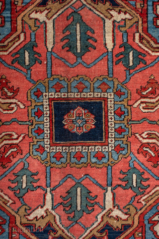 Antique Persian Heriz Carpet, circa 1900. Featuring a bold geometric medallion on a vibrant red field with deep indigo and ivory accents, framed by a classic Heriz border. Strong Northwest Persian design  ...