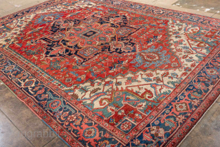 Antique Persian Heriz Carpet, circa 1900. Featuring a bold geometric medallion on a vibrant red field with deep indigo and ivory accents, framed by a classic Heriz border. Strong Northwest Persian design  ...