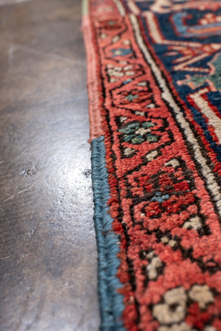 Antique Persian Heriz Carpet, circa 1900. Featuring a bold geometric medallion on a vibrant red field with deep indigo and ivory accents, framed by a classic Heriz border. Strong Northwest Persian design  ...
