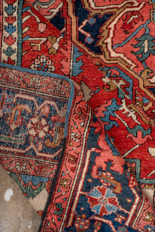 Antique Persian Heriz Carpet, circa 1900. Featuring a bold geometric medallion on a vibrant red field with deep indigo and ivory accents, framed by a classic Heriz border. Strong Northwest Persian design  ...
