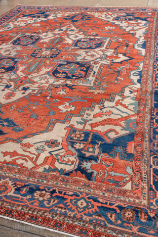 Antique Persian Serapi Carpet, circa 1900. Featuring a bold geometric medallion on a warm coral field with ivory and deep indigo accents, framed by a classic Heriz-style border. Grand Northwest Persian design  ...