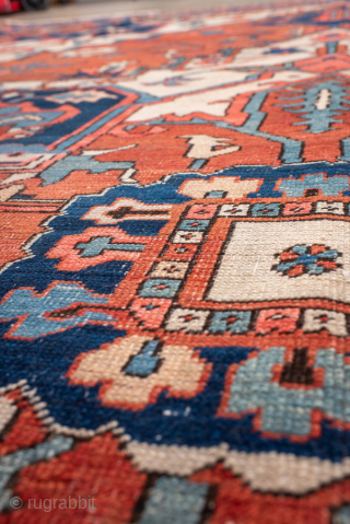 Antique Persian Serapi Carpet, circa 1900. Featuring a bold geometric medallion on a warm coral field with ivory and deep indigo accents, framed by a classic Heriz-style border. Grand Northwest Persian design  ...