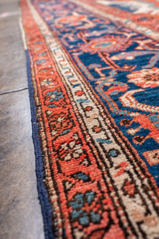 Antique Persian Serapi Carpet, circa 1900. Featuring a bold geometric medallion on a warm coral field with ivory and deep indigo accents, framed by a classic Heriz-style border. Grand Northwest Persian design  ...