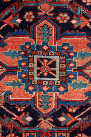 Antique Persian Heriz Carpet, circa 1900. Featuring a bold geometric medallion on a vibrant red field with deep indigo and ivory accents, framed by a classic Heriz border. Strong Northwest Persian design  ...