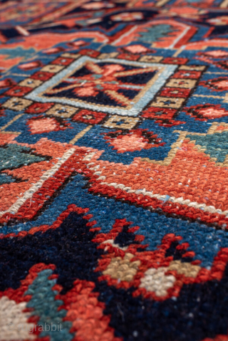 Antique Persian Heriz Carpet, circa 1900. Featuring a bold geometric medallion on a vibrant red field with deep indigo and ivory accents, framed by a classic Heriz border. Strong Northwest Persian design  ...