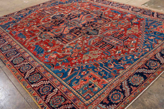 Antique Persian Heriz Carpet, circa 1900. Featuring a bold geometric medallion on a vibrant red field with deep indigo and ivory accents, framed by a classic Heriz border. Strong Northwest Persian design  ...