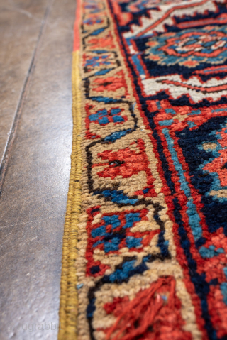 Antique Persian Heriz Carpet, circa 1900. Featuring a bold geometric medallion on a vibrant red field with deep indigo and ivory accents, framed by a classic Heriz border. Strong Northwest Persian design  ...