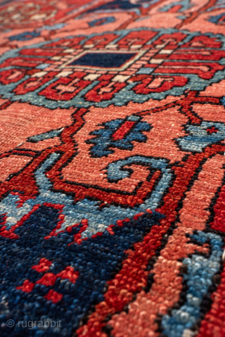 Antique Persian Serapi Carpet, circa 1900. Featuring a bold geometric medallion on a richly saturated red field, accented by deep navy, ivory, and soft sky-blue tones. The spacious composition is filled with  ...