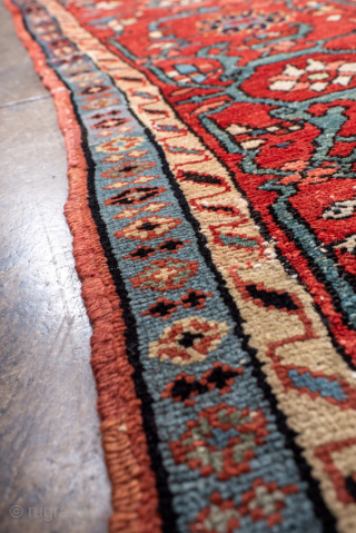 Antique Persian Serapi Carpet, circa 1900. Featuring a bold geometric medallion on a richly saturated red field, accented by deep navy, ivory, and soft sky-blue tones. The spacious composition is filled with  ...